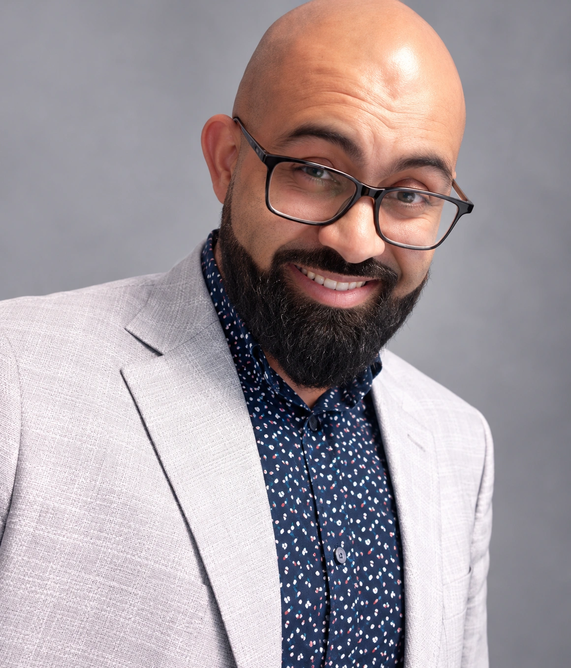 Shawn Bhatt smiling in a light sport coat